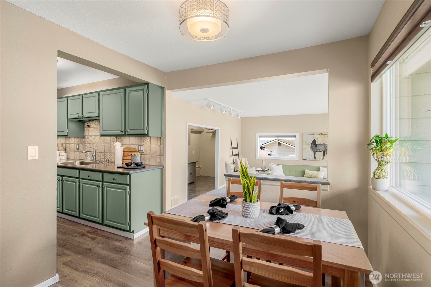 9537 South 213th Street Kent, WA 98031 - Photo 6 of 31 a kitchen with a table chairs appliances and cabinets
