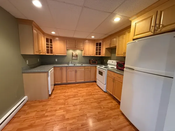 a kitchen with granite countertop a sink a counter top space stainless steel appliances and cabinets