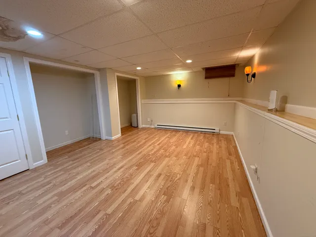 a view of a room with wooden floor