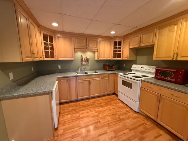 a kitchen with granite countertop a sink stainless steel appliances and cabinets