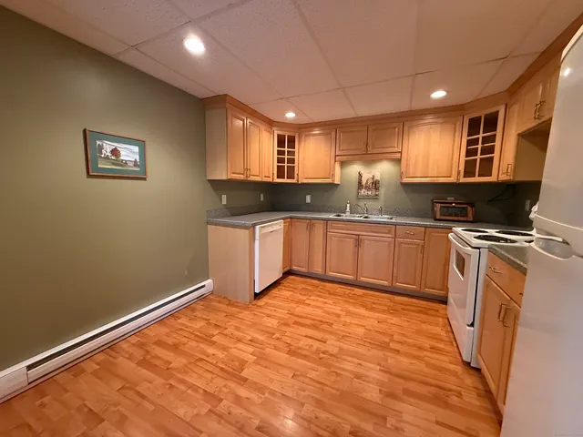 a kitchen with stainless steel appliances granite countertop a sink stove and cabinets