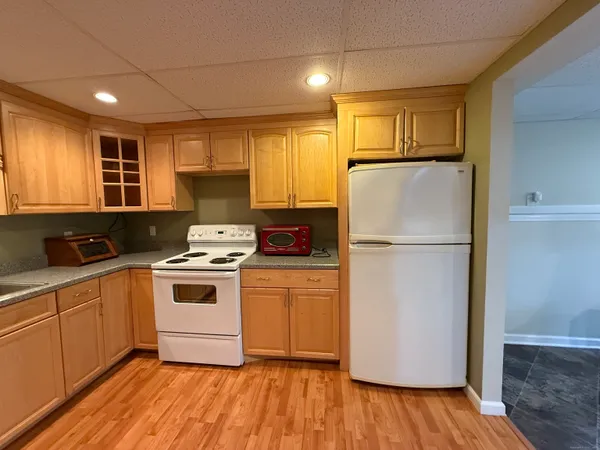 a kitchen with a refrigerator sink and cabinets