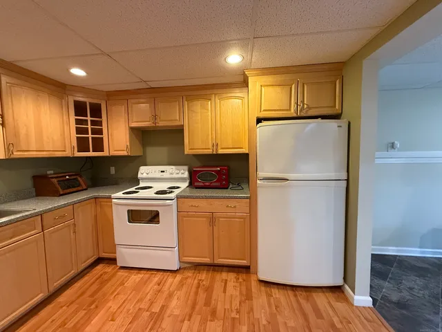 a kitchen with a refrigerator sink and cabinets