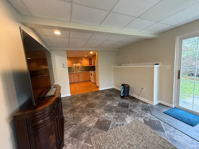 a view of a livingroom with furniture and a window