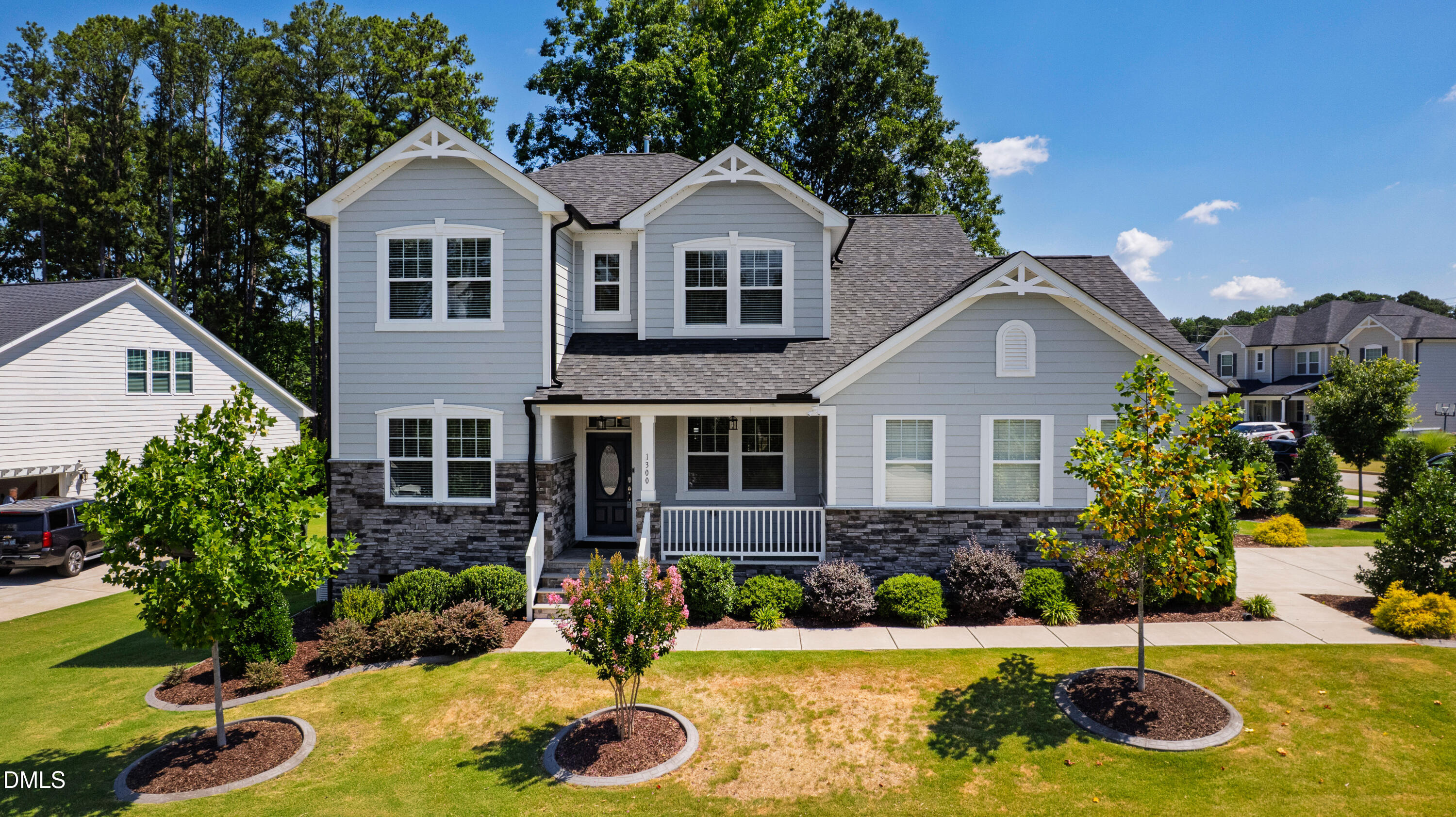 1300 Commons Ford Place Apex, NC 27539 - Photo 70 of 70 a front view of a house with yard and garage