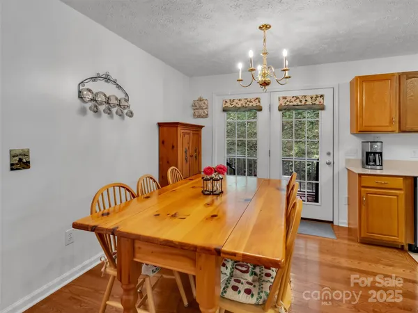 a view of a dining room and livingroom with furniture window and wooden floor