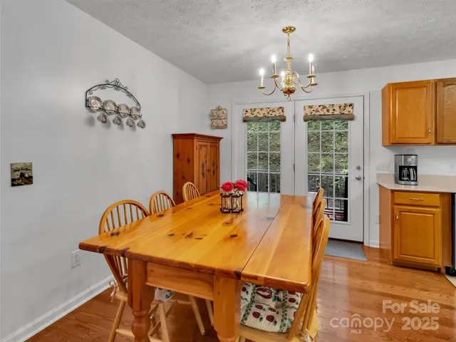 a view of a dining room and livingroom with furniture window and wooden floor
