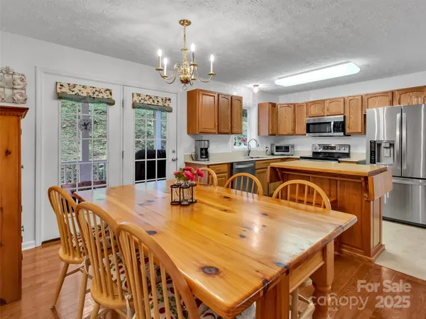 a kitchen with stainless steel appliances granite countertop a refrigerator stove microwave and sink