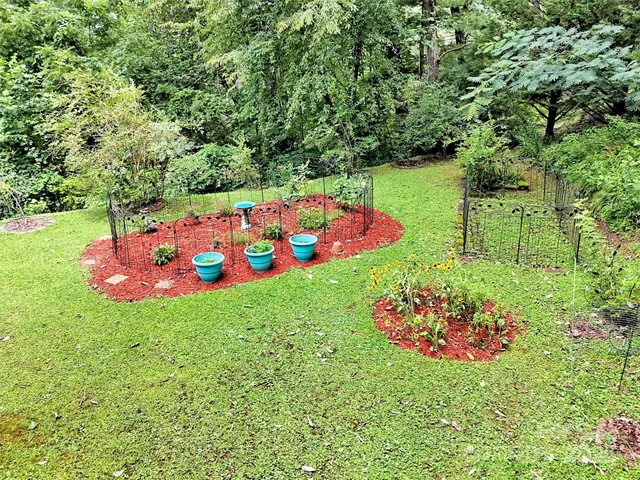 a view of a bench sitting in a yard with wooden fence