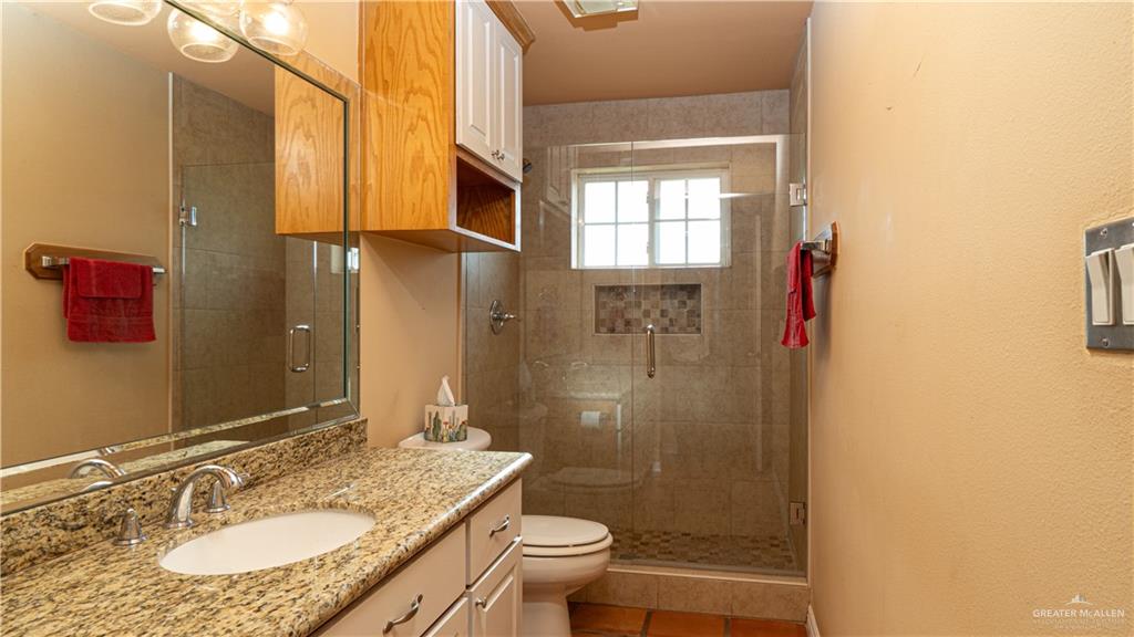 804 Inspiration Drive Pharr, TX 78577 - Photo 23 of 39 a bathroom with a granite countertop sink toilet and shower