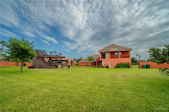 a view of a house with swimming pool and a yard