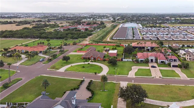 an aerial view of house with yard swimming pool and outdoor seating