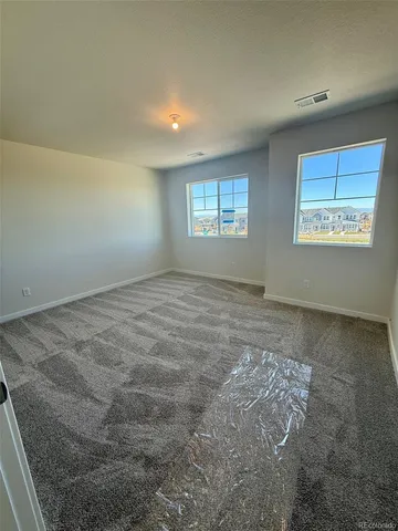 a view of a room with wooden floor and staircase