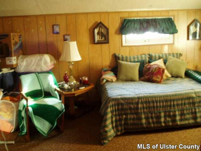 3533 Main Street Stone Ridge, NY 12484 - Photo 3 of 4 a bedroom with a bed and a painting on the wall