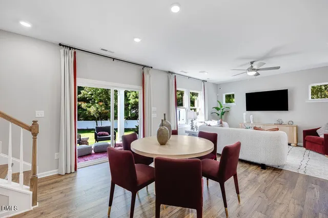 a kitchen with stainless steel appliances granite countertop a sink a stove a refrigerator and island with wooden floor