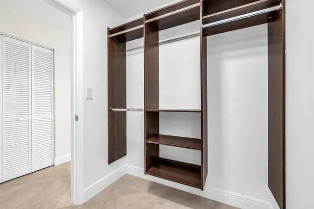 a view of empty room with ceiling fan