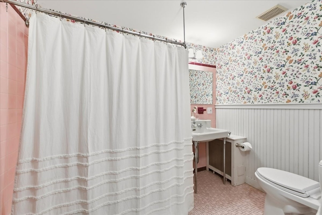 238 Harris Avenue Needham, MA 02492 - Photo 24 of 35 a bathroom with a sink a toilet and shower curtain