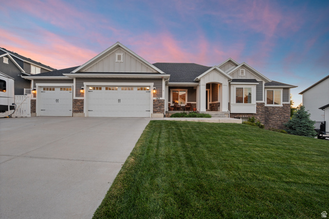 1145 North Christley Lane, Unit 48 Elk Ridge, UT 84651 - Photo 29 of 38 Contemporary rambler exterior featuring a stone and siding facade, a three-car garage, a covered front porch, and a bay window
