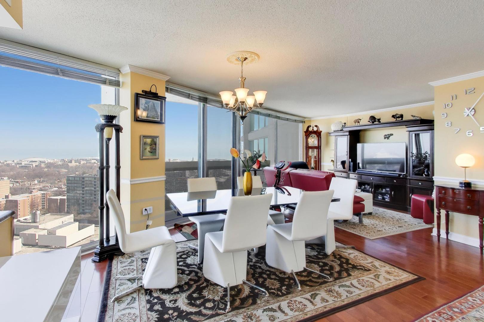 1720 Maple Avenue, Unit 2420 Evanston, IL 60201 - Photo 11 of 76 a view of a dining room with furniture wooden floor and chandelier