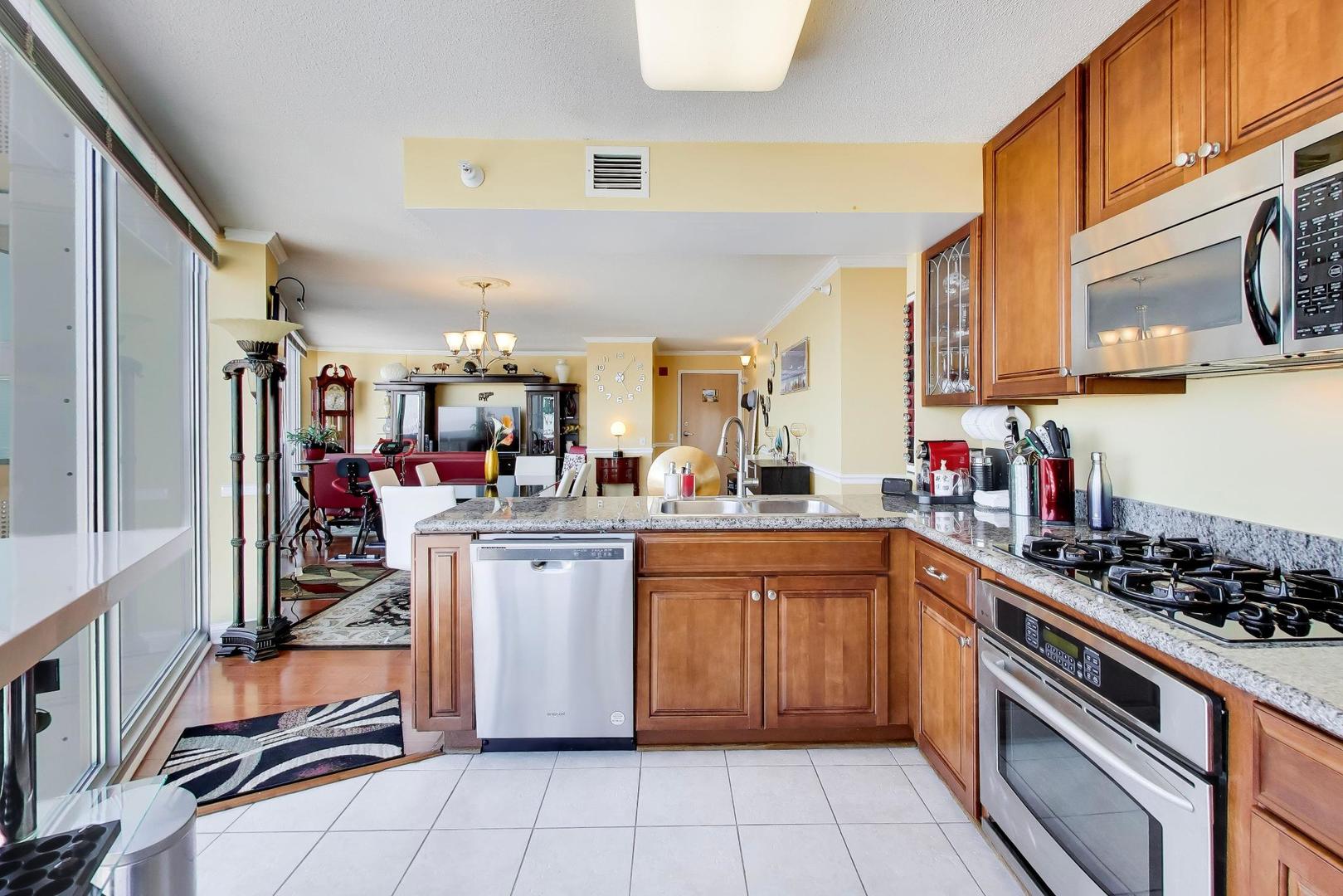 1720 Maple Avenue, Unit 2420 Evanston, IL 60201 - Photo 13 of 76 a kitchen with stainless steel appliances granite countertop a stove and a sink