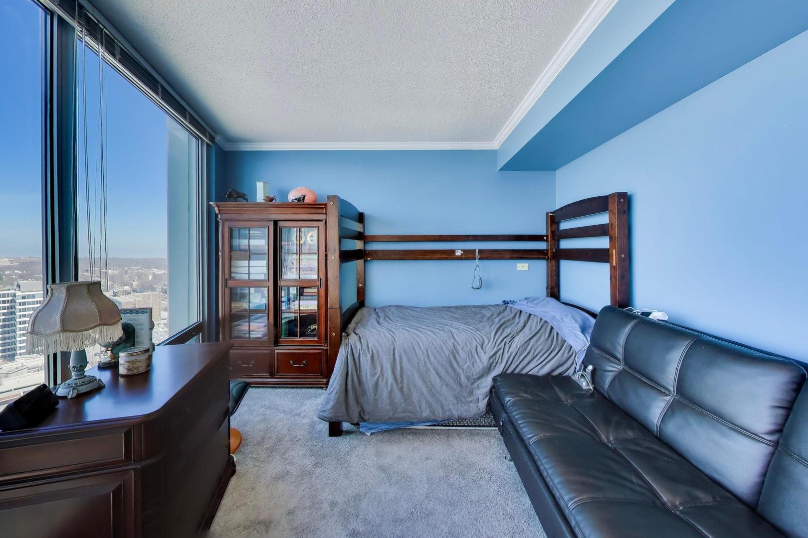 1720 Maple Avenue, Unit 2420 Evanston, IL 60201 - Photo 24 of 76 a bedroom with a bed and wooden floor