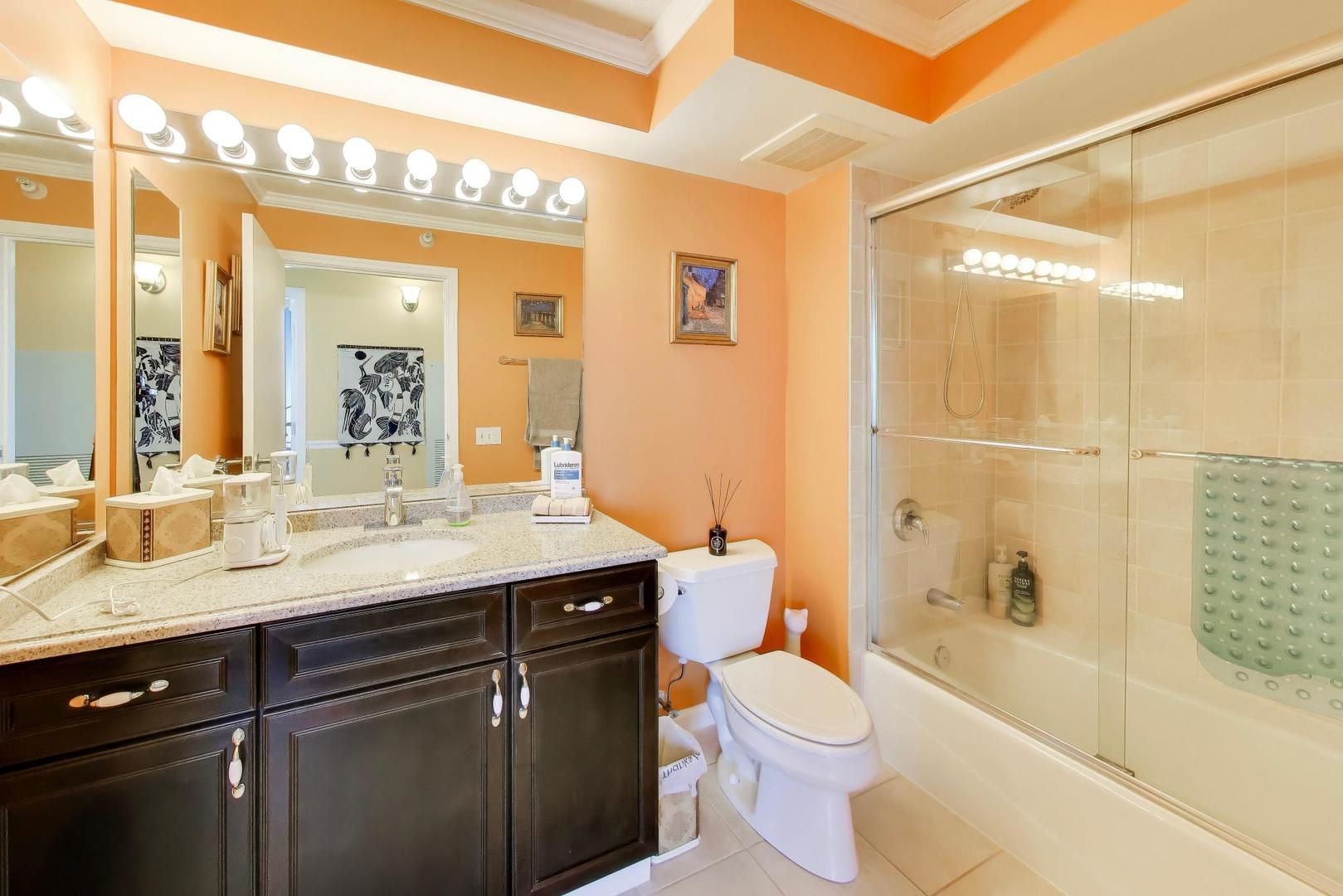 1720 Maple Avenue, Unit 2420 Evanston, IL 60201 - Photo 27 of 76 a bathroom with a granite countertop sink toilet a large mirror a bathtub and shower