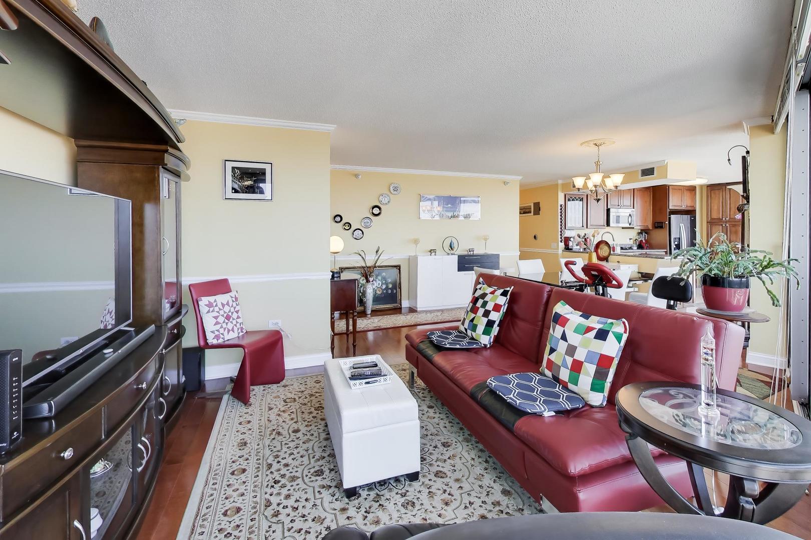 1720 Maple Avenue, Unit 2420 Evanston, IL 60201 - Photo 9 of 76 a living room with furniture and a flat screen tv