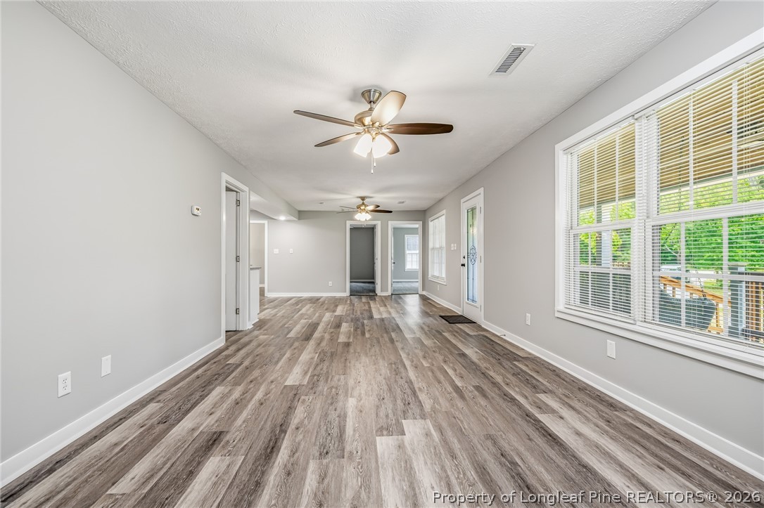 3524 Pine Log Road Lumberton, NC 28360 - Photo 7 of 42 a view of empty room with wooden floor and fan