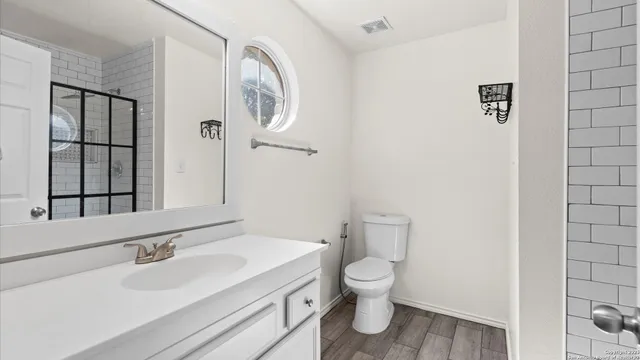 a view of an empty room with wooden floor