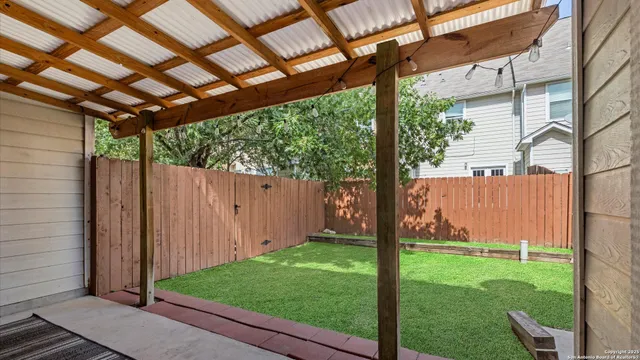 a view of a house with backyard porch and sitting area