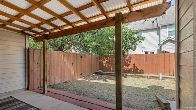 a row of palm trees in front of a house