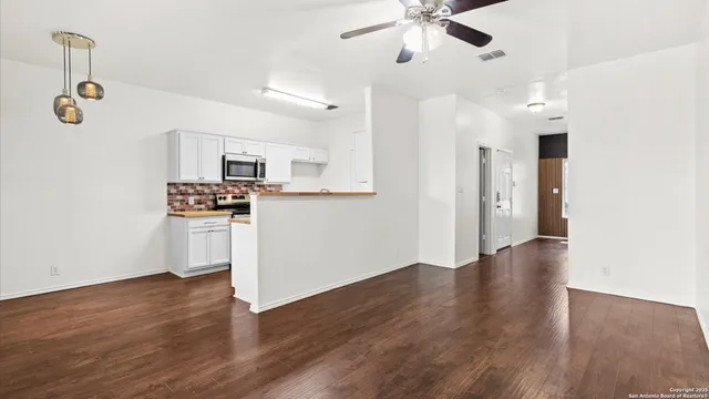 a kitchen with stainless steel appliances granite countertop a sink and a stove