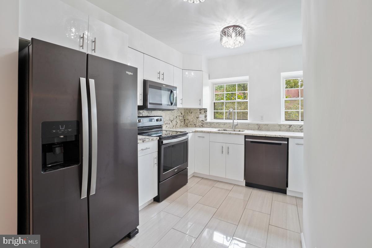 2134 Golf Course Drive Reston, VA 20191 - Photo 12 of 55 a kitchen with a sink stove and refrigerator