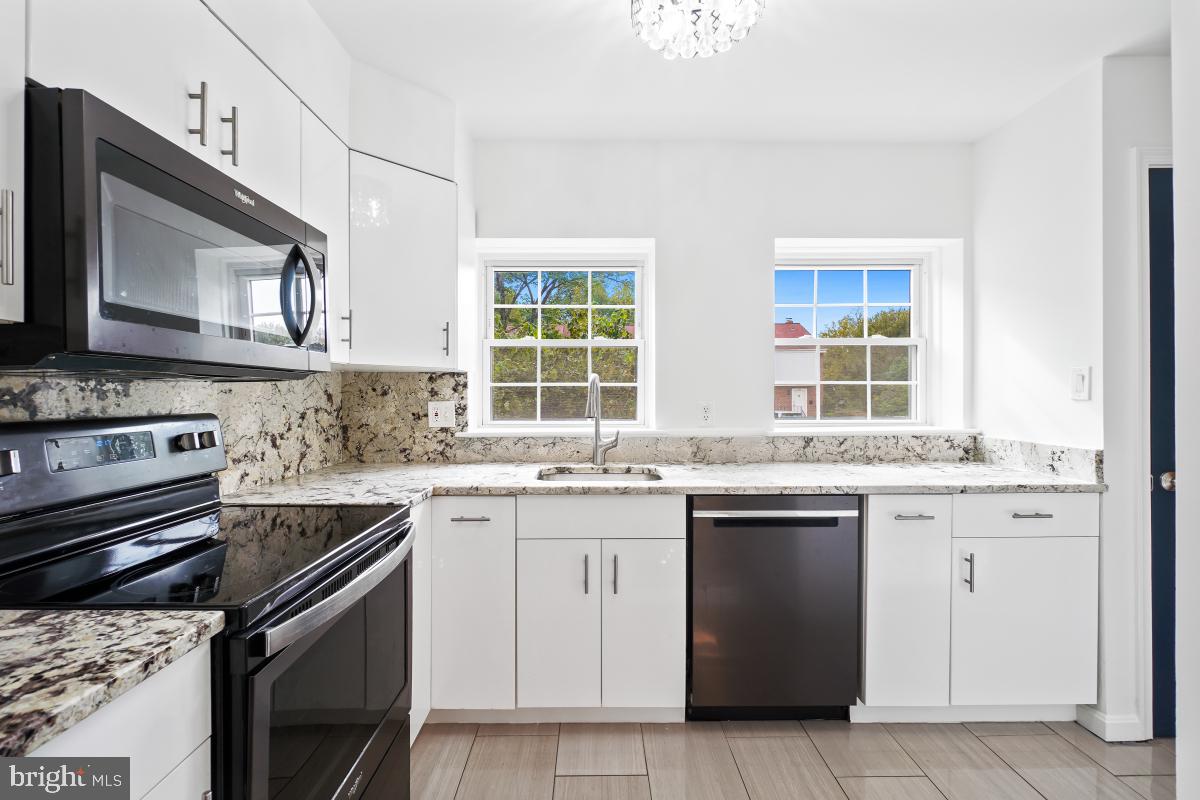 2134 Golf Course Drive Reston, VA 20191 - Photo 13 of 55 a kitchen with a sink stove and cabinets