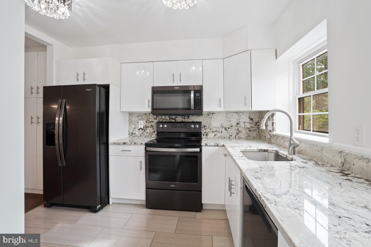 2134 Golf Course Drive Reston, VA 20191 - Photo 14 of 55 a kitchen with granite countertop a refrigerator stove and sink