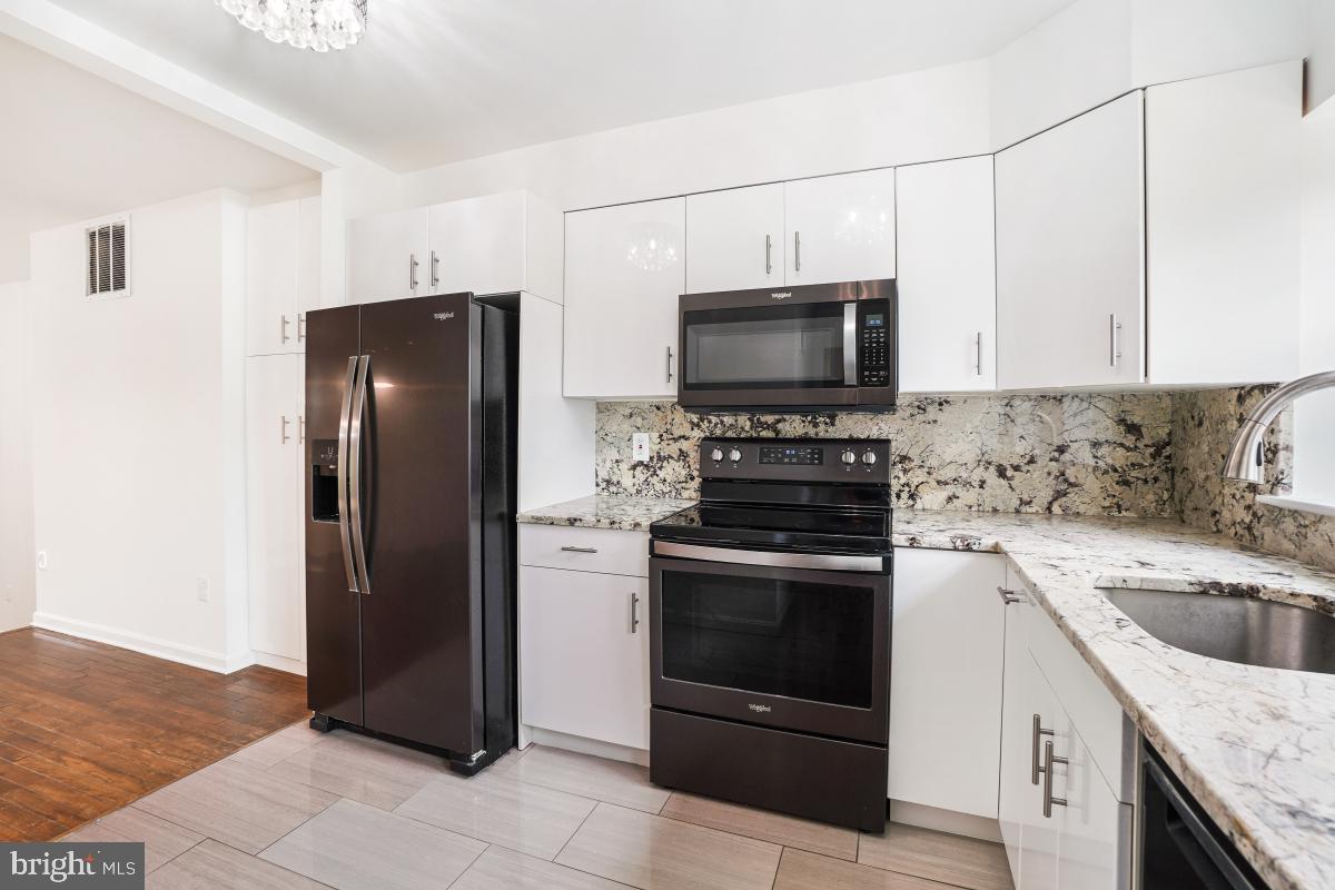 2134 Golf Course Drive Reston, VA 20191 - Photo 17 of 55 a kitchen with stainless steel appliances granite countertop a refrigerator stove and sink