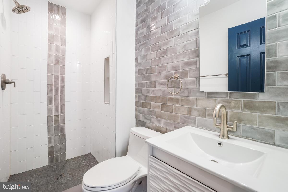 2134 Golf Course Drive Reston, VA 20191 - Photo 30 of 55 a bathroom with a sink a toilet and shower