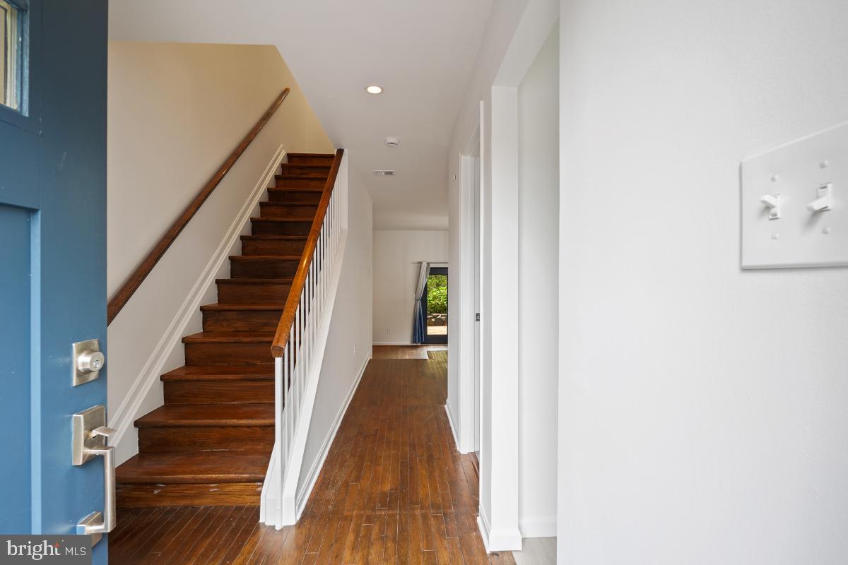 2134 Golf Course Drive Reston, VA 20191 - Photo 3 of 55 a view of a hallway with wooden floor and entryway