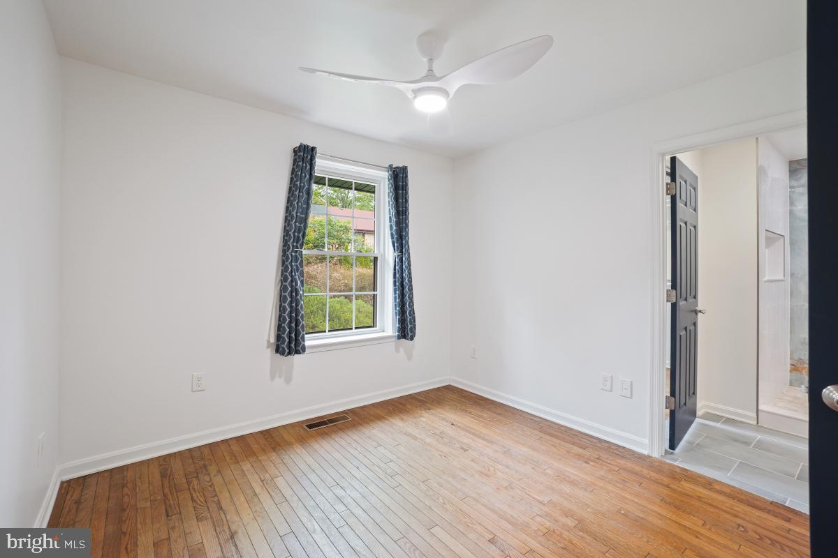 2134 Golf Course Drive Reston, VA 20191 - Photo 33 of 55 an empty room with wooden floor and windows