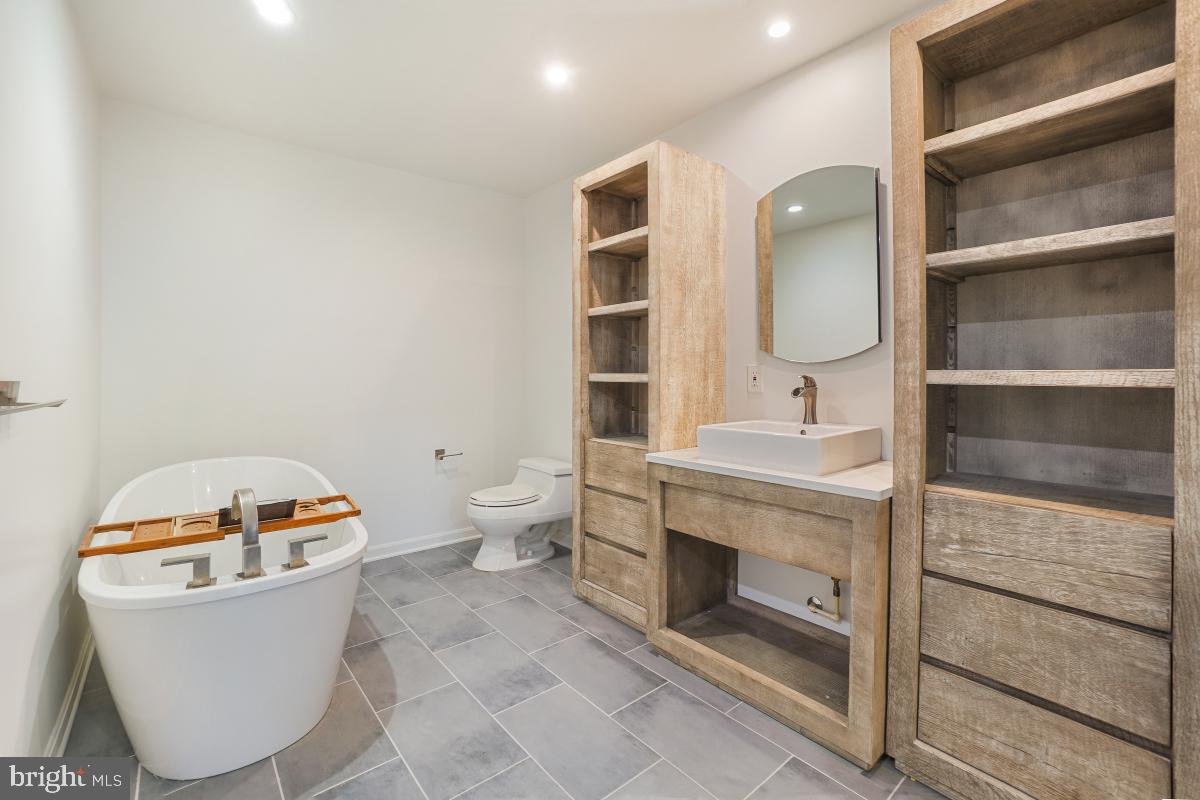 2134 Golf Course Drive Reston, VA 20191 - Photo 37 of 55 a bathroom with a toilet a sink and a mirror