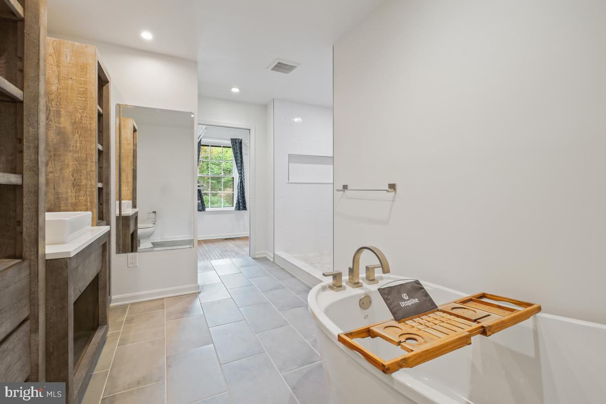 2134 Golf Course Drive Reston, VA 20191 - Photo 38 of 55 a spacious bathroom with a bathtub and a sink