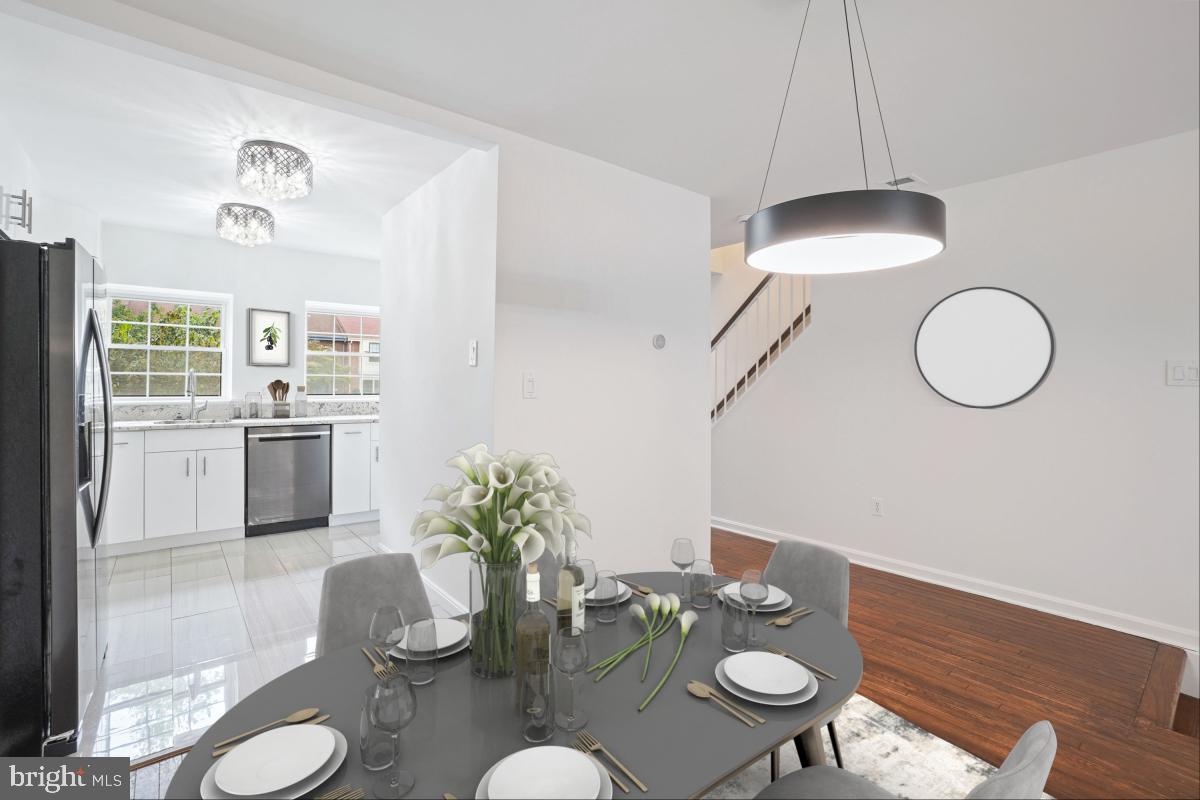 2134 Golf Course Drive Reston, VA 20191 - Photo 7 of 55 a dining room with furniture a kitchen wooden floor and a chandelier