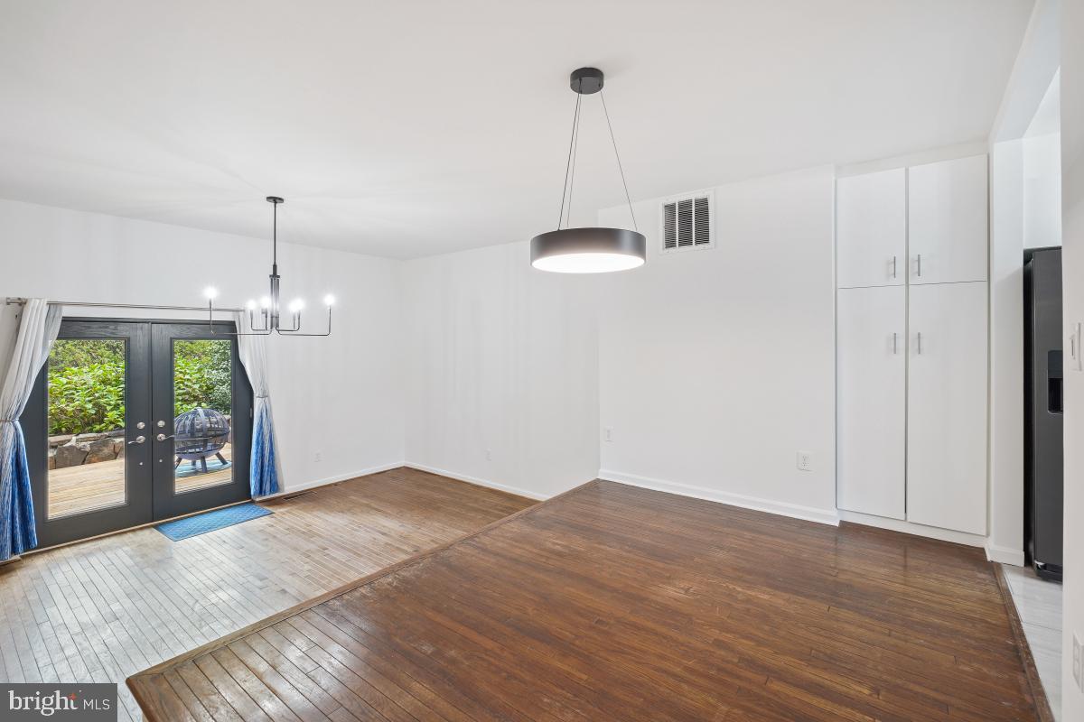 2134 Golf Course Drive Reston, VA 20191 - Photo 8 of 55 a view of an empty room with a window and wooden floor