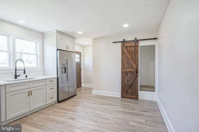 a view of a kitchen with a sink and refrigerator