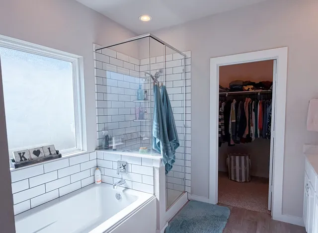 a bathroom with a bathtub and a shower