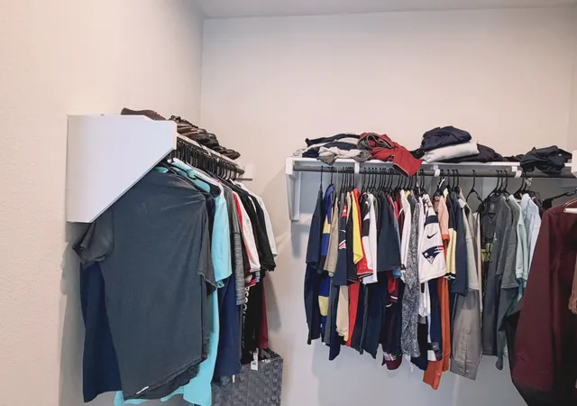 a view of walk in closet with clothes