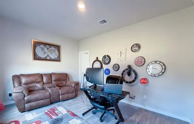a living room with furniture and a wooden floor