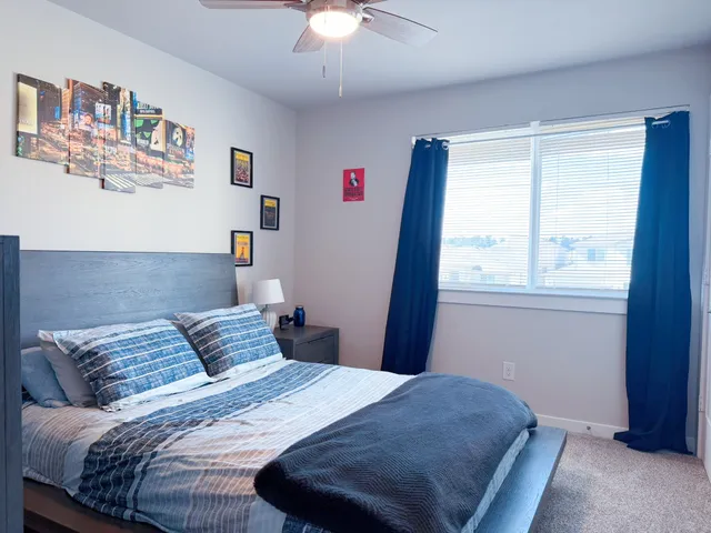 a bedroom with a bed and window