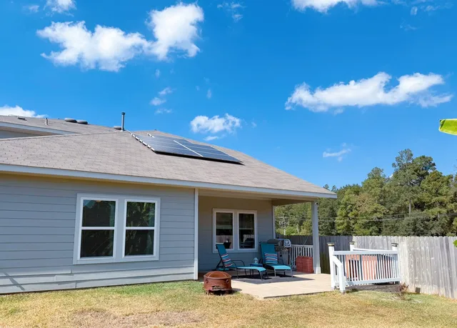 a view of backyard with wooden fence
