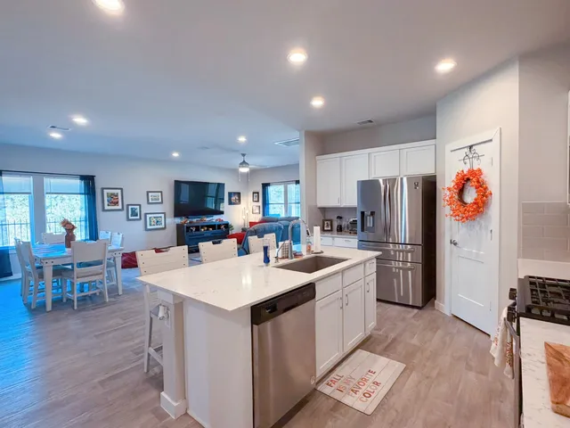 a large kitchen with stainless steel appliances lots of counter top space